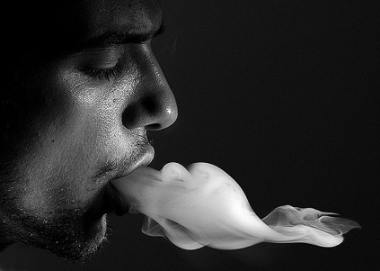 man smoking black and white